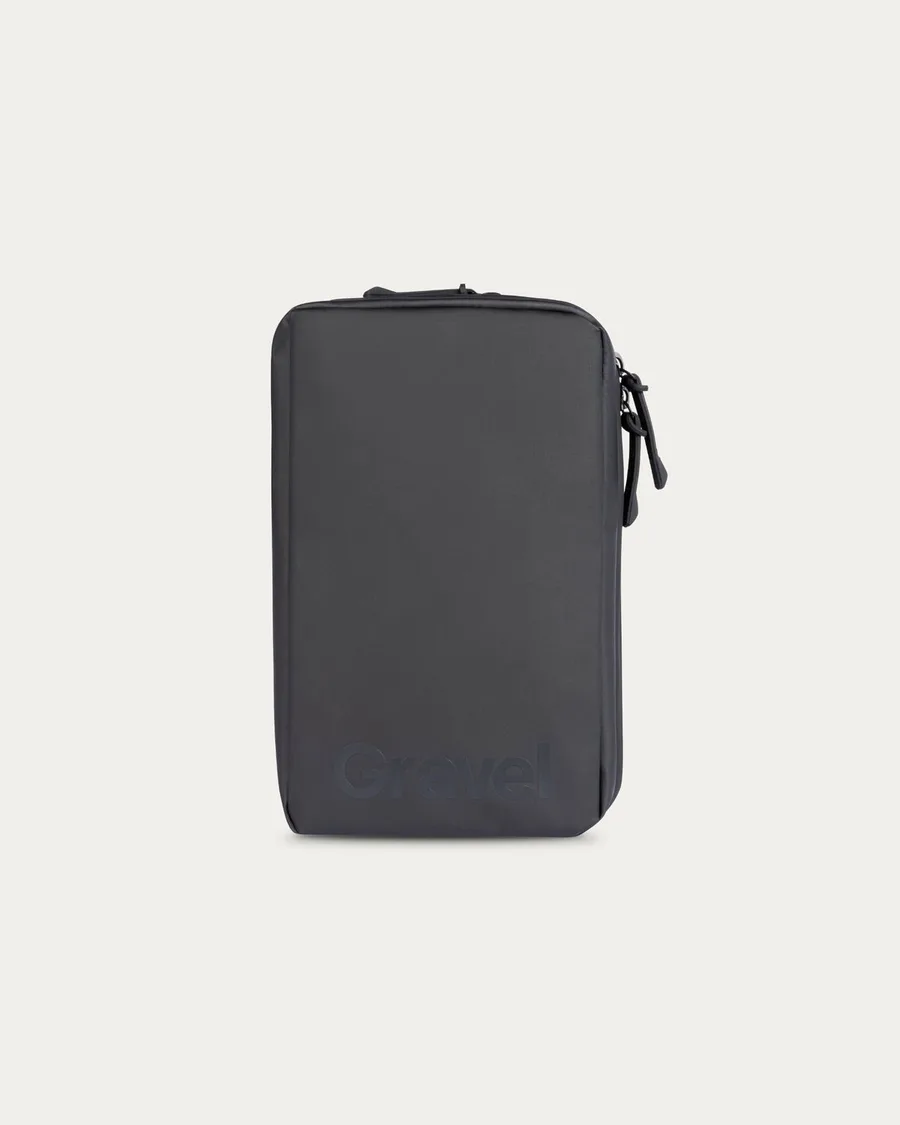 The Gravel Explorer Plus toiletry bag in black, a slim rectangular kit with a water-resistant coated shell and the Gravel logo